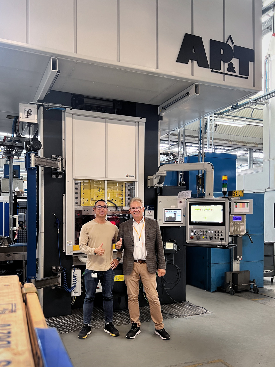 Peter Lund Pedersen from Grundfos and Peter Karlsson from AP&T celebrate the installation of a one-of-a-kind servo press system they developed jointly. The system features freely programmable controls, real-time energy consumption monitoring, and up to 85% reduction in energy consumption per stroke.